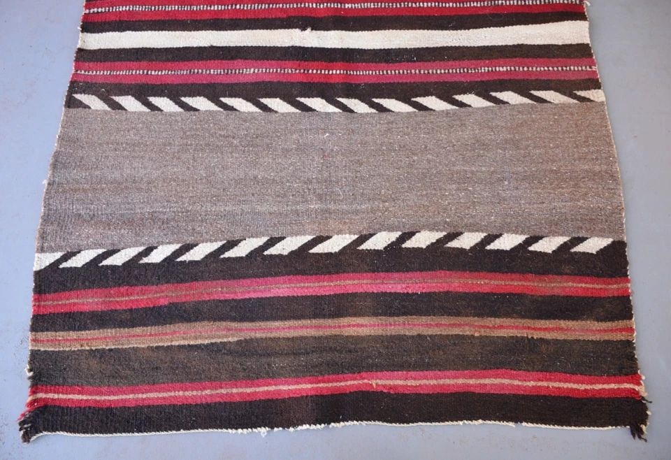 OLD NAVAJO TRANSITIONAL BANDED BLANKET 63" X 45": OLD NAVAJO TRANSITIONAL BANDED BLANKET 63" X 45" This old banded Navajo blanket has three wide bands with some deep reds and dark browns. This rug is in fair to poor condition because of the 2 large h