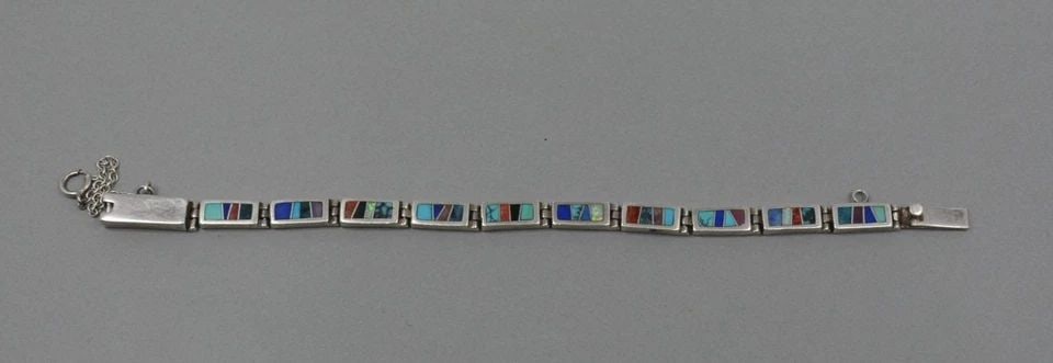 VINTAGE NAVAJO SILVER LINK BRACELET MULTICOLOR INLAY TOUCH OF SANTA FE - 7 5/8": VINTAGE NAVAJO SILVER LINK BRACELET MULTICOLOR INLAY TOUCH OF SANTA FE - 7 5/8" Sterling Silver Navajo Link Bracelet with inlay of Turquoise, Lapis, Coral and other semi-precious stones. Signed Touch 