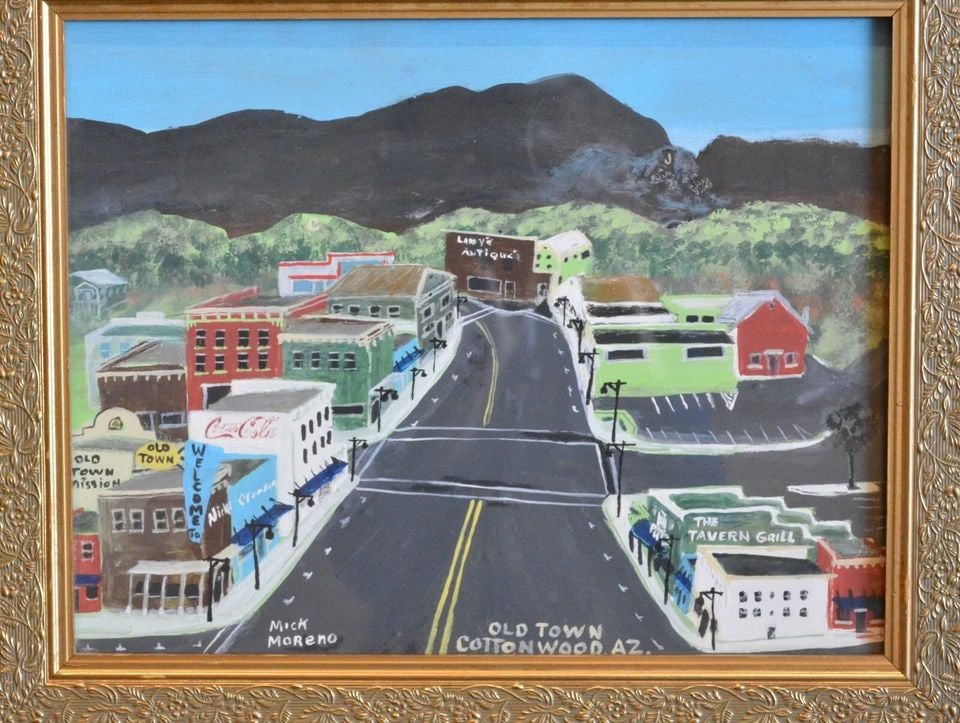 MICK MORENO - FOLK ART PAINTING OLD TOWN COTTONWOOD JEROME AZ CITYSCAPE - FRAMED: MICK MORENO - FOLK ART PAINTING OLD TOWN COTTONWOOD JEROME AZ CITYSCAPE - FRAMED Item Description: This folk art painting shows Main Street in Old Town Cottonwood Arizona and the small town of Jerome 