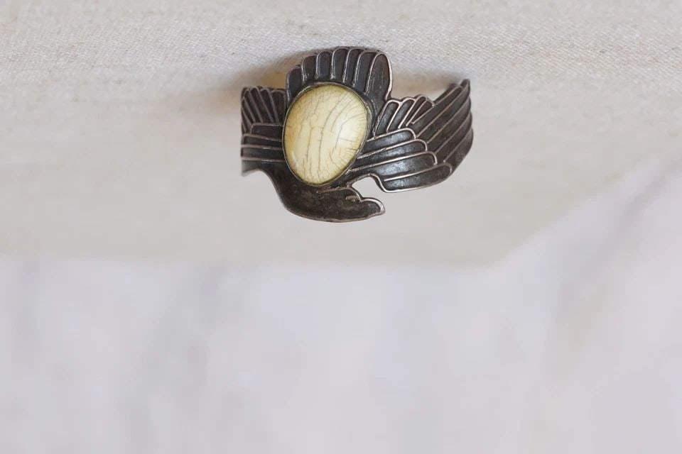 EAGLE STERLING SILVER BRACELET WITH LIGHT STONE 1 3/4 TALL: EAGLE STERLING SILVER BRACELET WITH LIGHT STONE 1 3/4 TALL 1 3/4 Tall ..5" Inside With a 1 1/4" Opening ..49.7 Grams Throughout the 40 years that I have been in business, I have purchased jewelry from