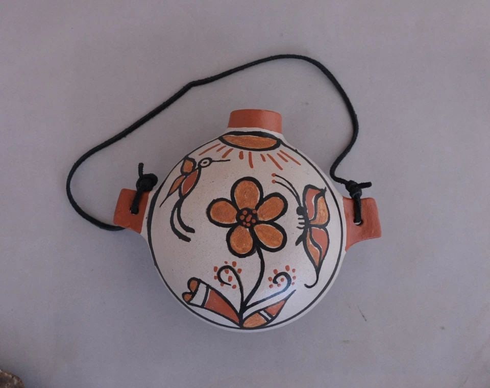 ROSE PACHECO - SANTO DOMINGO PUEBLO (KEWA) CANTEEN POT - BUTTERFLY FLOWER: ROSE PACHECO - SANTO DOMINGO PUEBLO (KEWA) CANTEEN POT - BUTTERFLY FLOWER This canteen pot has been beautifully crafted by Santo Domingo (Kewa) potter Rose Pacheco. It measures 5 1/2" tall by 7" handl