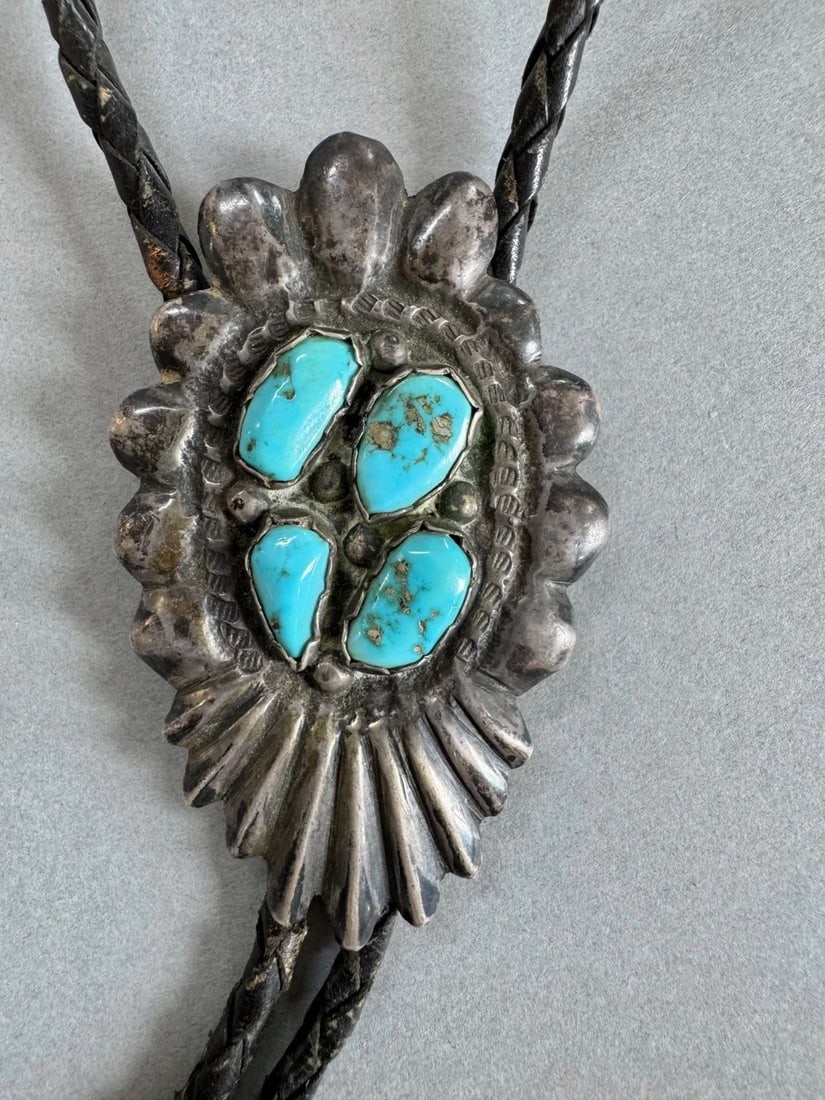 OLD PAWN NAVAJO STERLING SILVER AND TURQUOISE BOLO TIE: 2 1/2 " x 1 1/2 " Bolo Silver tips One has dents ..34" strap " 46 Grams Throughout the 40 years that I have been in business, I have purchased jewelry from pawn shops throughout the Southwest that had