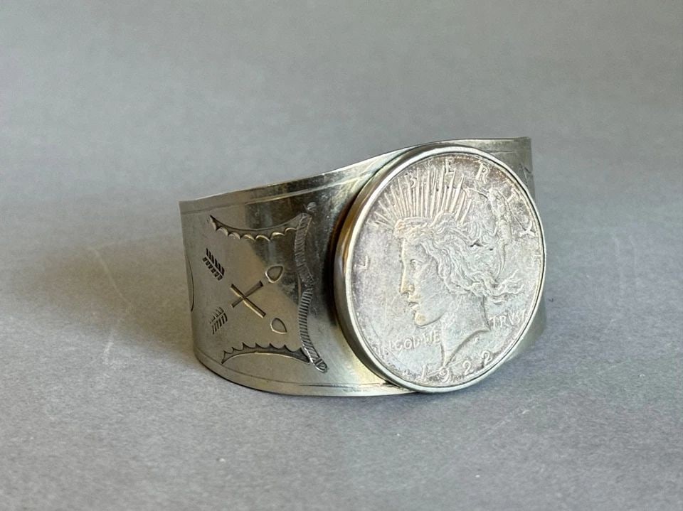 OLD PAWN NAVAJO NICKEL SILVER BRACELET WITH SILVER DOLLAR COIN 1922: OLD PAWN NAVAJO NICKEL SILVER BRACELET WITH SILVER DOLLAR COIN 1922 Old Pawn Navajo Nickel Silver Bracelet Stamped with Silver Dollar Coin. 1922 ..1 1/2 Tall 5 1/4 " Inside with a 1 1/8 " Opening ..