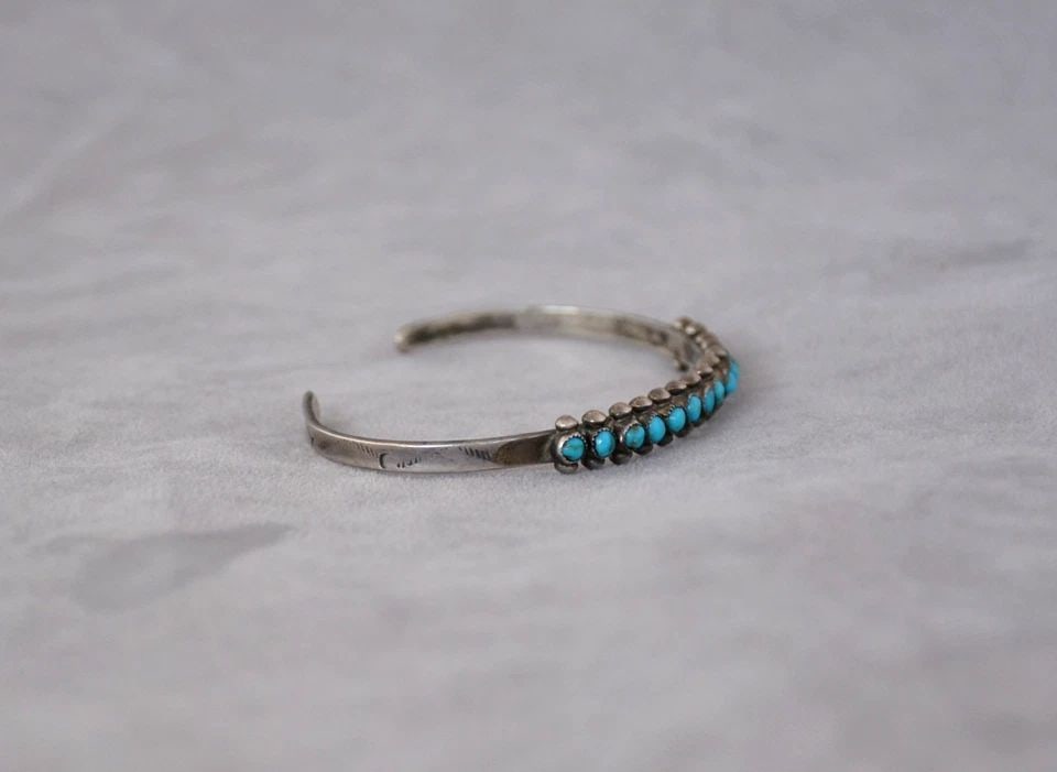 OLD PAWN ZUNI STERLING SILVER TURQUOISE ROW BRACELET - 14 STONES - 6 1/4": Old pawn Zuni sterling silver row bracelet has been set with 14 turquoise stones. The front of the bracelet is 1/4" tall. The bracelet size is 5 1/4" around the inside plus an additional 1" opening at