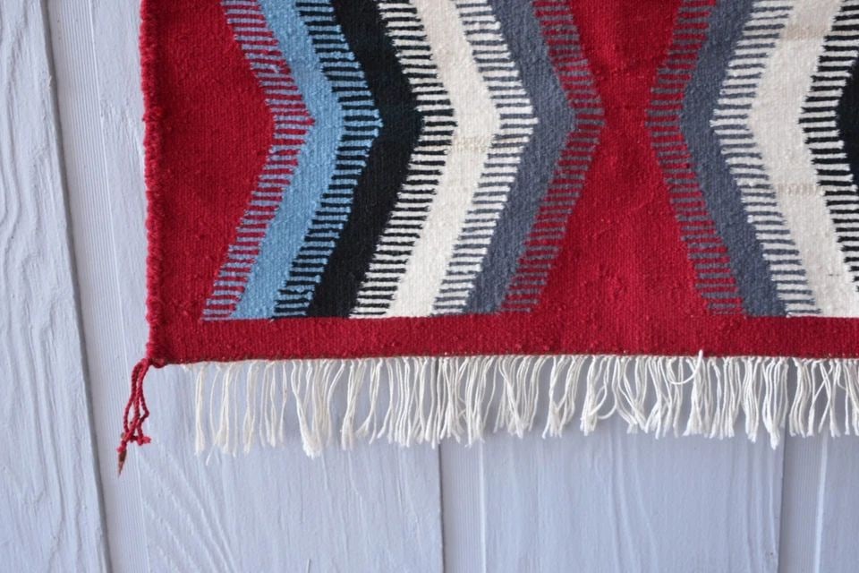 NAVAJO RUG EYE DAZZLER PATTERN - RED GREY BLACK WHITE BLUE - 36" X 28.5": NAVAJO RUG EYE DAZZLER PATTERN - RED GREY BLACK WHITE BLUE - 36" X 28.5" Measures 36" x 28.5" not including 3" fringe. Navajo rug **Both sides of the rug are shown in the photos.**