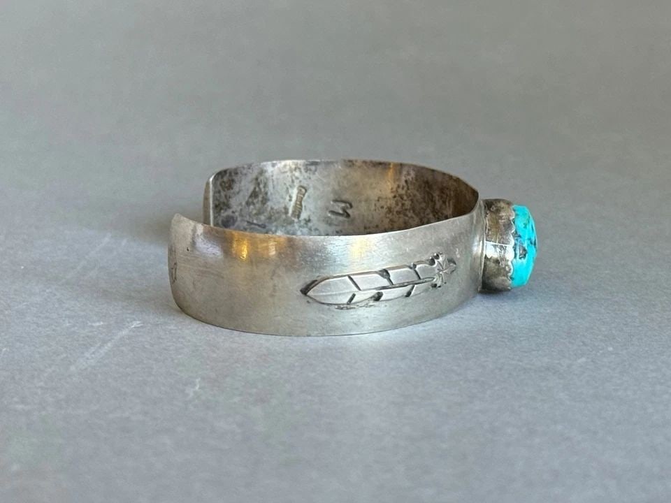 VINTAGE NAVAJO STERLING SILVER AND TURQUOISE BRACELET WITH FEATHERS SIGNED M: VINTAGE NAVAJO STERLING SILVER AND TURQUOISE BRACELET WITH FEATHERS SIGNED M Vintage Navajo Sterling Silver and Turquoise Bracelet with Feathers. 1/2" Wide .. 5" Inside with a 1 1/4" Opening ..