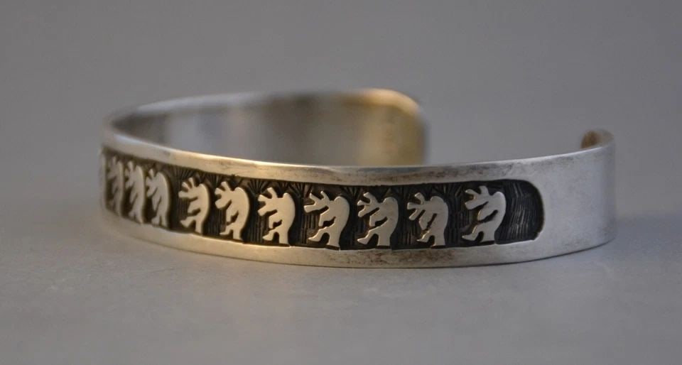 VINTAGE HOPI STERLING SILVER OVERLAY BRACELET - FLUTE PLAYER - 7 3/8": VINTAGE HOPI STERLING SILVER OVERLAY BRACELET - FLUTE PLAYER - 7 3/8" This vintage Hopi bracelet has a flute player in silver overlay. The bracelet size is 6 1/4" around the inside plus an additional 