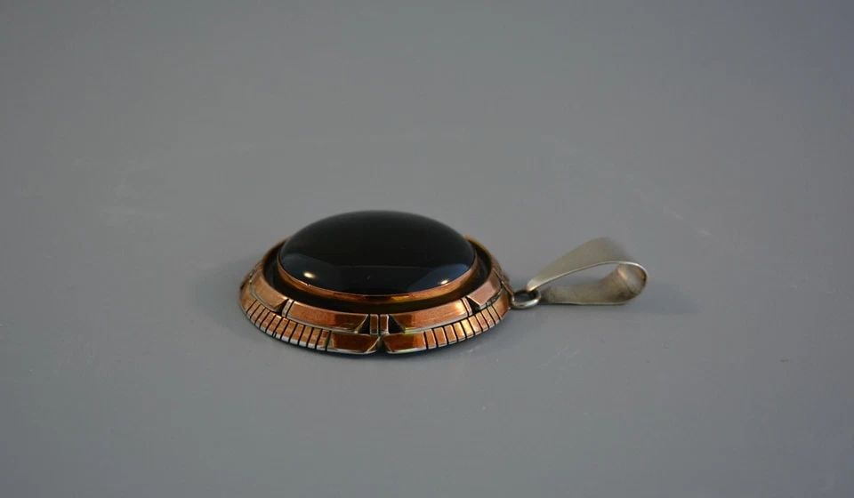 LARGE NAVAJO STERLING SILVER PENDANT - BEAUTIFUL BLACK ONYX STONE - FIJ: LARGE NAVAJO STERLING SILVER PENDANT - BEAUTIFUL BLACK ONYX STONE - FIJ Item Description: This large sterling silver pendant has a beautifully shaped and polished black onyx stone surrounded with a ha