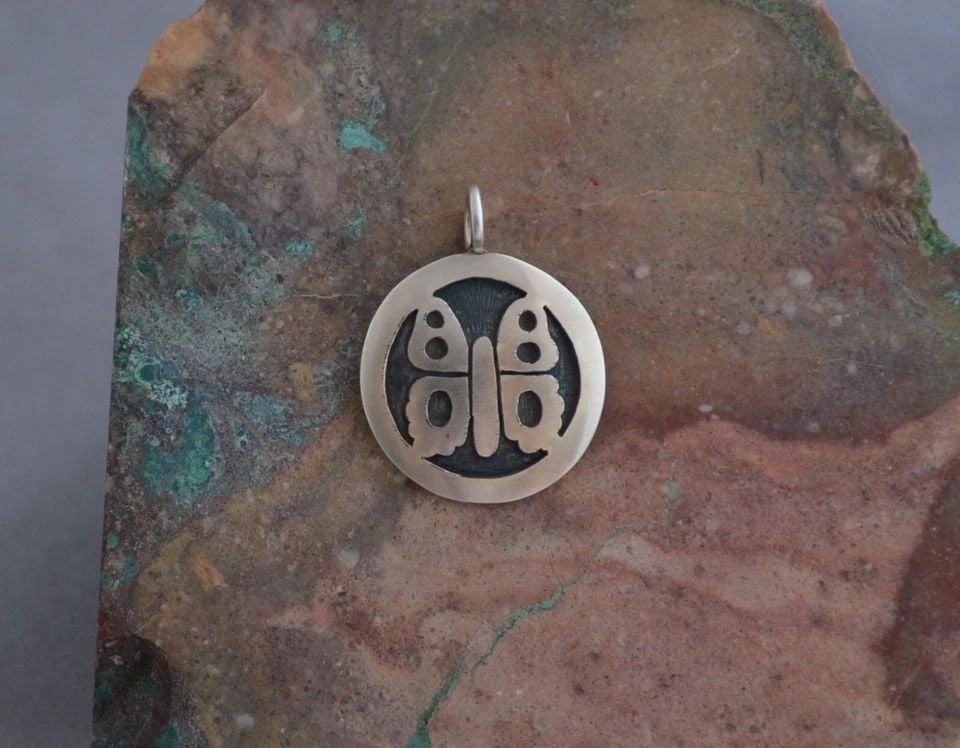 MANUEL HOYUNGOWA (1953-2011 - HOPI STERLING SILVER ROUND PENDANT BUTTERFLY 1.25": MANUEL HOYUNGOWA (1953-2011 - HOPI STERLING SILVER ROUND PENDANT BUTTERFLY 1.25" This sterling silver pendant has been beautifully crafted by the Hopi artists Manuel and Karen Hoyungwa. The pendant sh