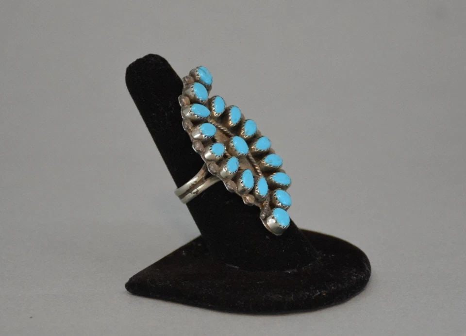 LARGE VINTAGE NAVAJO RING - 17 TURQUOISE STONES - SZ 7.5 - 2" TALL: LARGE VINTAGE NAVAJO RING - 17 TURQUOISE STONES - SZ 7.5 - 2" TALL This large old pawn Navajo ring has 17 vibrant blue turquoise stones set into serrated bezel. The silver is nickel silver. not sterli