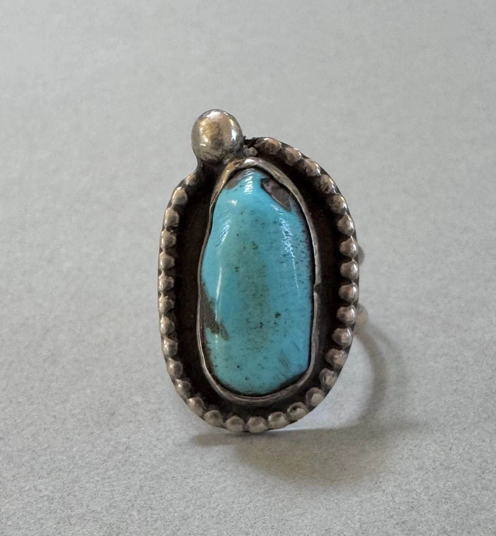 OLD PAWN NAVAJO STERLING SILVER AND TURQUOISE RING SIZE 7 1/2: 1" Tall 6.5 Grams Throughout the 40 years that I have been in business, I have purchased jewelry from pawn shops throughout the Southwest that had collections of dead pawn. Most of these pawn shops an