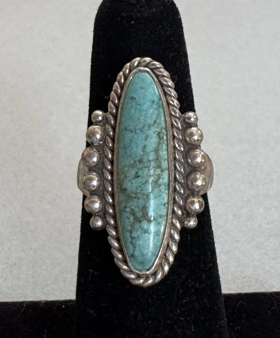 OLD PAWN NAVAJO STERLING SILVER TURQUOISE RING SIZE 5 1/4: 1" Tall 6.6 Grams Throughout the 40 years that I have been in business, I have purchased jewelry from pawn shops throughout the Southwest that had collections of dead pawn. Most of these pawn shops an