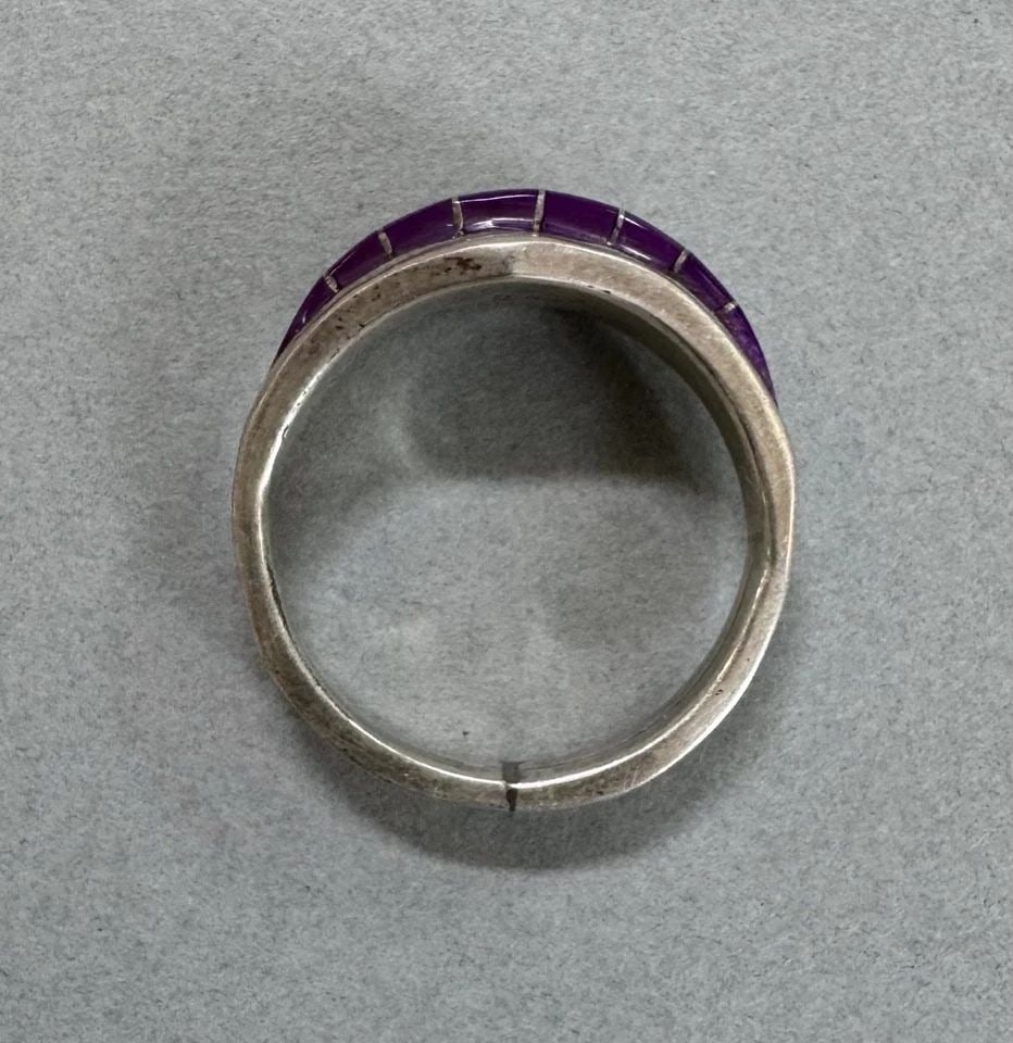 ZUNI NATIVE STERLING SILVER AND SUGILITE RING SIZE 11 SIGNED: 3/8 " Wide 5.7 Grams Throughout the 40 years that I have been in business, I have purchased jewelry from pawn shops throughout the Southwest that had collections of dead pawn. Most of these pawn shops