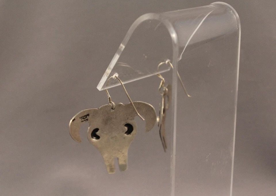 VINTAGE NAVAJO SILVER COW HEAD EARRINGS SIGNED YAZZIE: VINTAGE NAVAJO SILVER COW HEAD EARRINGS SIGNED YAZZIE Item Description: 1 3/4”Tall X 1 1/2” wide From top of wire to bottom of earring
