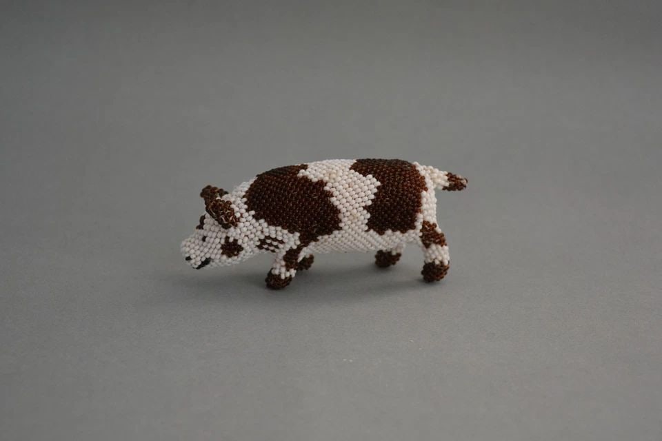 ZUNI HAND BEADED SPOTTED PIG FIGURINE - TILDON MARTZA - 4" LONG X 1 3/4": ZUNI HAND BEADED SPOTTED PIG FIGURINE - TILDON MARTZA - 4" LONG X 1 3/4" This wonderful spotted pig has been beautifully crafted by Zuni artist Tildon Martza. It measures 4" long by 1 3/4" high. This 