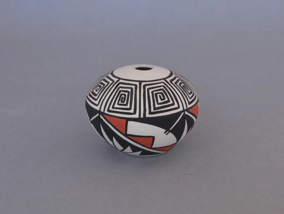 J. P. TORIVIO - SMALL SEED JAR POT - HANDPAINTED POLYCHROME DESIGNS - 2 1/8": J. P. TORIVIO - SMALL SEED JAR POT - HANDPAINTED POLYCHROME DESIGNS - 2 1/8" This small seed jar has been beautifully crafted by T. P. Torivio of the Acoma Pueblo. It is 2 1/8" tall and approximately 