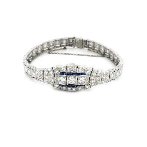 DIAMOND PLATINUM BRACELET GEMSTONE SECTION LINKS MILGRAIN BORDER ART DECO: This beautiful vintage Art Deco diamond platinum bracelet features an intricate centerpiece with larger set round natural diamonds accented with blue gemstones. The links on each side are small rectan