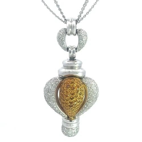 DIAMONDS GOLD PUFFED PENDANT ALL NATURAL 18K TWO TONE TRIPLE CHAIN NECKLACE: This eye-catching pendant and triple chain necklace is a stunning 18k white and yellow gold featuring a puffed pendant almost a heart like dome shape, yellow in the center with yellow diamonds and whi