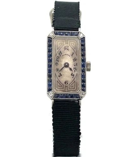 ART DECO DIAMOND PLATINUM LADIES WRISTWATCH: ART DECO DIAMOND PLATINUM LADIES WRISTWATCH This is a vintage Art Deco platinum quartz ladies watch, the frame is a rectangle shape with blue color stones around the bezel and a diamond on each corner