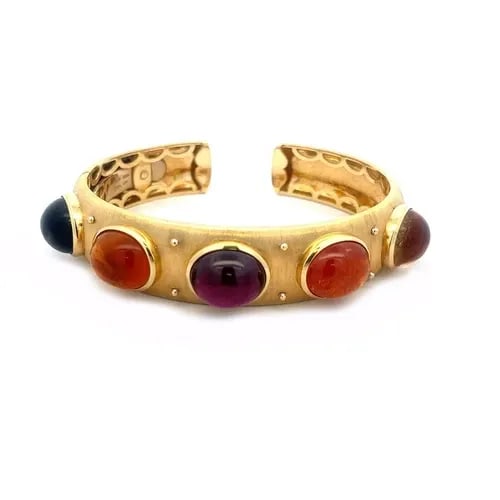 GOLD 18K CUFF BRACELET YELLOW MULTICOLOR GEMS LARGE OVAL CABOCHON STYLE: GOLD 18K CUFF BRACELET YELLOW MULTICOLOR GEMS LARGE OVAL CABOCHON STYLE This is a beautiful 18k yellow gold cuff bracelet with a fine brush finish. The front part of the 14.5mm wide band has 5 bezel s