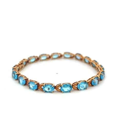 VINTAGE 21.00CT OVAL SHAPE BLUE TOPAZ TENNIS BRACELET IN 18K YELLOW GOLD: VINTAGE 21.00CT OVAL SHAPE BLUE TOPAZ TENNIS BRACELET IN 18K YELLOW GOLD PRODUCT DESCRIPTION Title: Vintage 21.00ct Oval Shape Blue Topaz Tennis Bracelet in 18K Yellow Gold Style: Tennis Metal: 18 Kar