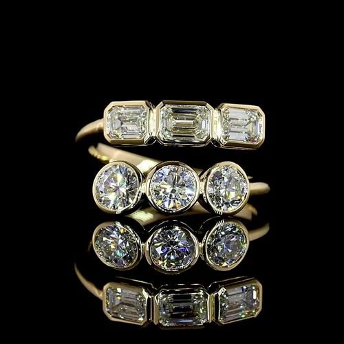 0.78 CARAT ROUND BRILLIANT AND EMERALD CUT DIAMOND 18K YELLOW GOLD BAND RING (1 of 2)