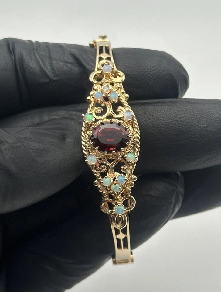 14K YELLOW GOLD BANGLE BRACELET WITH GARNET AND OPALS (7 INCH) 15.5 GRAMS (1 of 2)