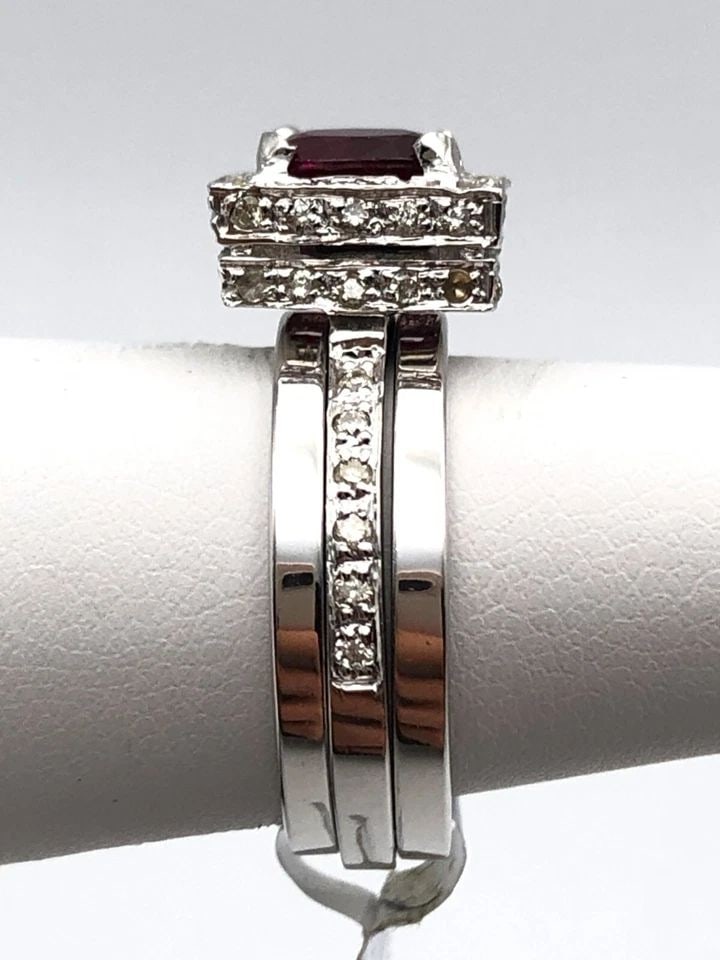 18K WHITE GOLD THREE RING SET, 1.0CT RUBY, 0.56CTS OF DIAMONDS ( SIZE: 5 ) 9.4G: 18K WHITE GOLD 3 RING SET, CENTER RUBY AND 0.56CTS OF DIAMONDS SIZE: 5 18k White Gold 3 Ring Set, Center Ruby and 0.56cts of Diamonds Condition: New with original tag Material: 18k White Gold Ring Siz