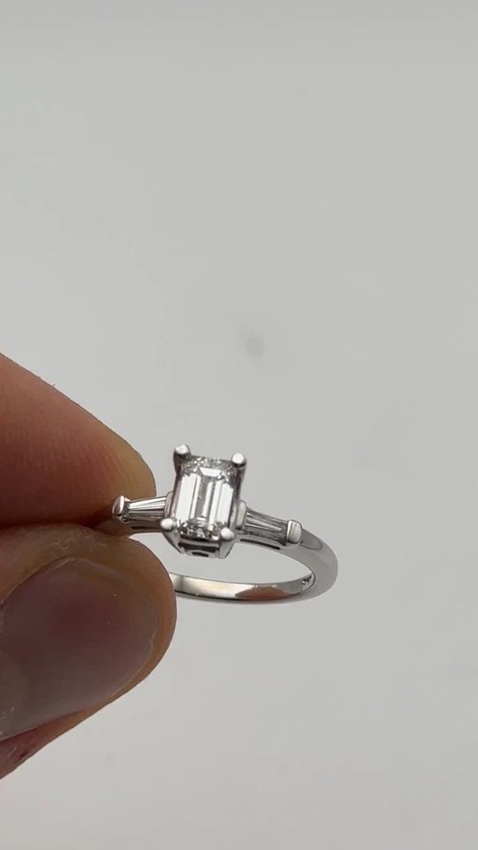 14K WHITE GOLD RING WITH 0.88CTS OF VS DIAMONDS, 0.66CT CENTER SIZE: 6.25: 14k White Gold Ring with 0.88cts of Diamonds Condition: Used Material: 14k White Gold Ring Size: 6.25 Weight: 3 grams Top Width: 6.8mm Bottom Width: 1.6mm Stone Info: Center is a emerald cut Diamond t