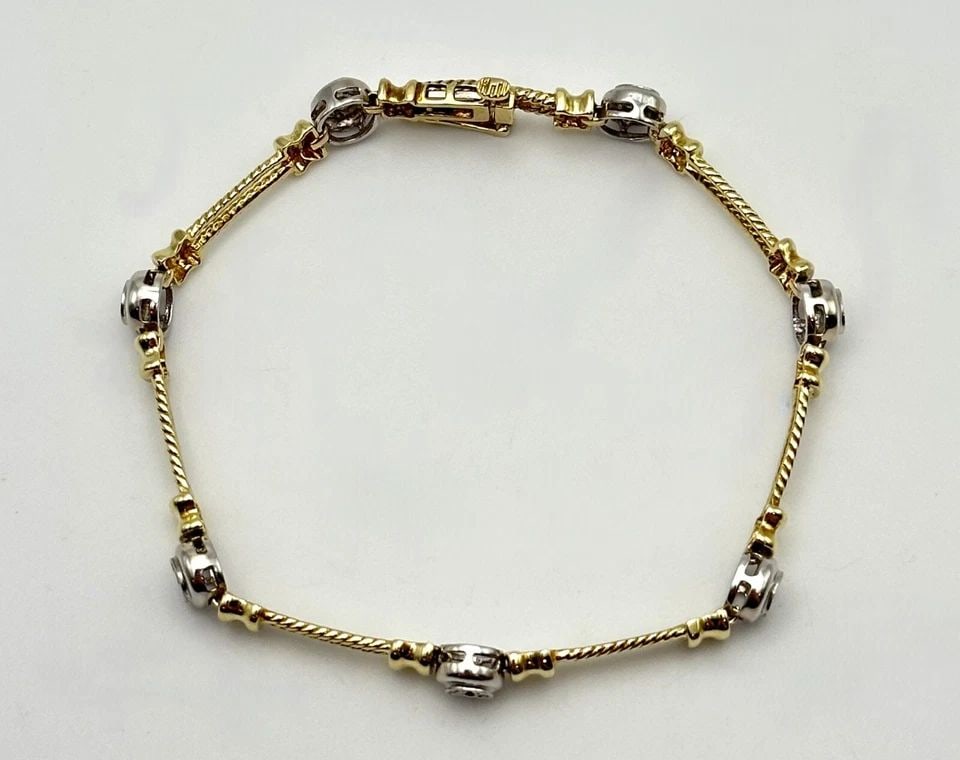 10K TWO TONED GOLD BRACELET WITH 0.17CTS OF DIAMONDS (7 INCH) 8.2 GRAMS: 10k Two Toned Bracelet with 0.17cts of Diamonds Condition: Used, has been cleaned Material: 10k Yellow and White Gold Weight: 8.2 grams Bracelet Size: 7 inches long, 6mm wide Bracelet Type: Double Bar