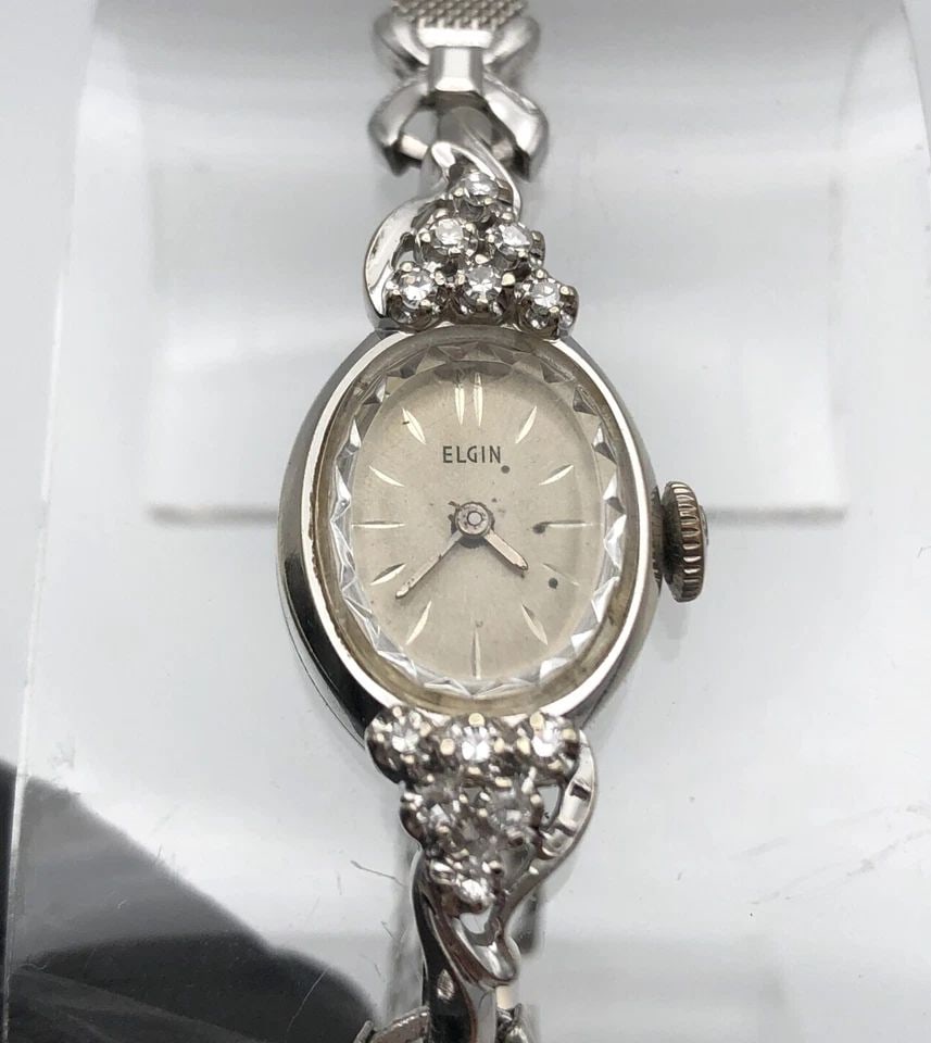 VINTAGE ELGIN 14K WHITE GOLD WATCH SET WITH 0.25CTS OF DIAMONDS 17 JEWELS: WOMAN'S VINTAGE ELGIN 14K WHITE GOLD WATCH SET WITH 0.25CTW DIAMONDS Woman's vintage Elgin 14k White Gold Watch set with 0.25cts of Diamonds Condition: Used, runs and keeps time Material: 14k White Go