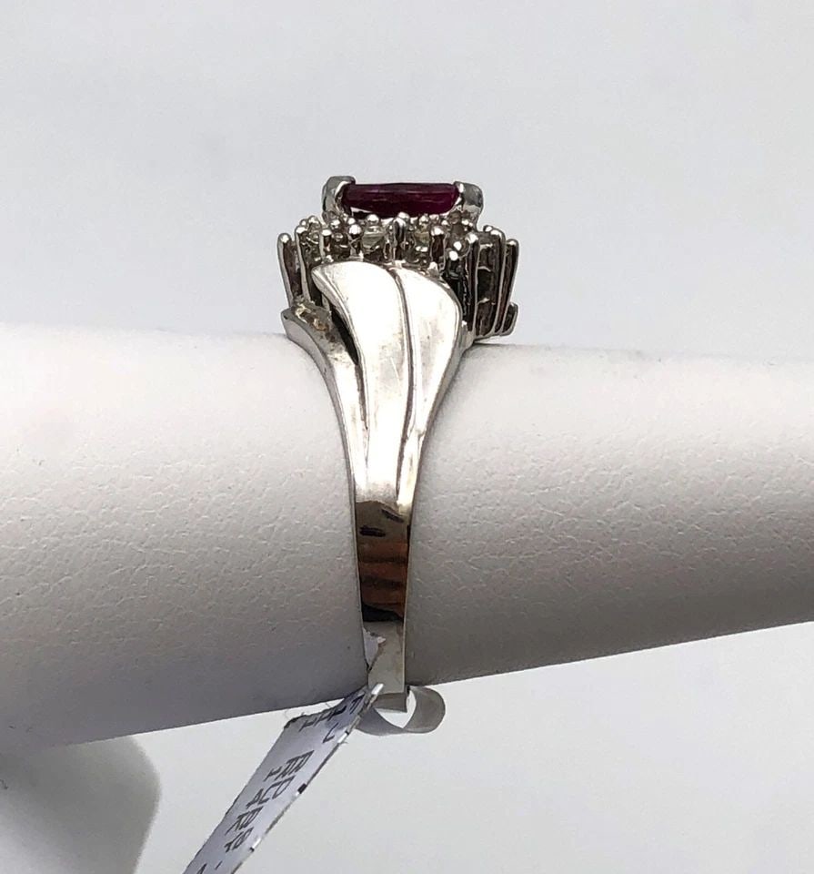 NEW 14K WHITE GOLD RING WITH NATURAL RUBY AND DIAMONDS (SIZE 6.5) 4.1 GRAMS: 14K WHITE GOLD RING WITH CENTER RUBY AND 0.15CTS OF DIAMONDS SIZE: 6.5 14k White Gold Ring with center Ruby and 0.15cts of Diamonds Condition: New with original Tag, display model Material: 14k White 