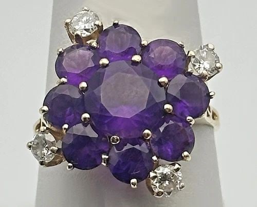10K GOLD FLOWER RING WITH AMETHYST AND 0.56CTW DIAMONDS (SIZE 8.5) 4.3 GRAMS: 10k Gold Flower Themed Ring with Amethyst and 0.56cts of Diamonds Condition: Used, has been cleaned and inspected by our in house Jewelers. Material: 10k Yellow gold Ring Size: 8.5 Weight: 4.3 grams T