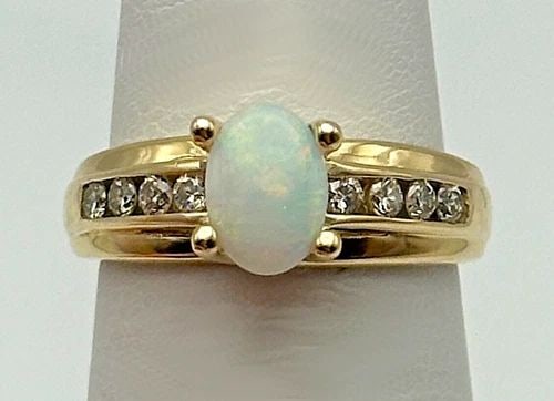 10K GOLD RING WITH NATURAL OPAL AND 0.16CTW DIAMONDS (SIZE 5) 2.9 GRAM: 10K GOLD RING WITH NATURAL OPAL AND 0.16CTS OF DIAMONDS SIZE: 5 10k Gold Ring with natural Opal and 0.16cts of Diamonds Condition: Used Material: 10k Yellow Gold Ring Size: 5 Weight: 2.9 grams Top Wid