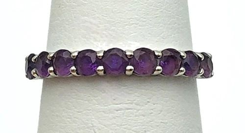 14K WHITE GOLD BAND SET WITH 1.0CTS OF AMETHYSTS (SIZE: 6.75) 2 GRAMS: 14K WHITE GOLD BAND SET WITH 1.00CTS OF AMETHYSTS SIZE: 6.75 14k White Gold Band set with 1.00ct of Amethyst Condition: Used Material: 14k White Gold Ring Size: 6.75 Weight: 2 grams Top Width: 3mm Bot