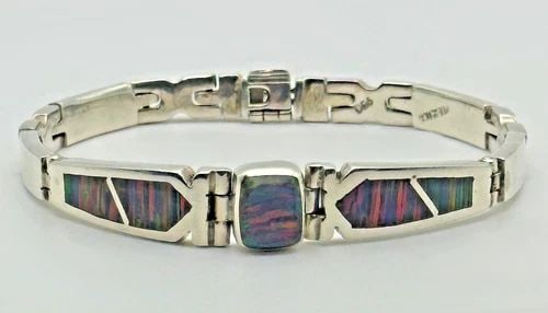 90% SILVER BRACELET WITH MEXICAN BLUE FIRE OPAL ( 8.25 INCH ) 43.5 GRAMS: 90% SILVER BRACELET WITH MEXICAN BLUE FIRE OPAL 8.25" 43.5 GRAMS 90% Silver Bracelet with Mexican Blue Fire Opal Condition: Used, has mark scratches and signs of use Material: 900 Silver, 90%. Bracele