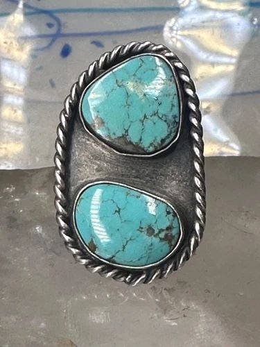 NAVAJO LONG RING TURQUOISE SIZE 8 STERLING SILVER WOMEN: NAVAJO LONG RING TURQUOISE SIZE 8 STERLING SILVER WOMEN Navajo long ring turquoise size 8 sterling silver women girls Size 8 Weight 10.2g Length. 1 3/8" Width 7/8" Thinnest part of band in back. 3/16"