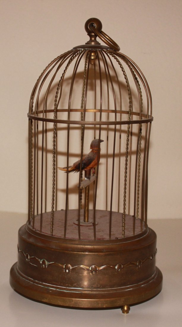 Tweeting Mechanical Bird: Winding mechanical tweeting bird in a cage. Stamp made in Germany. 12" in height.