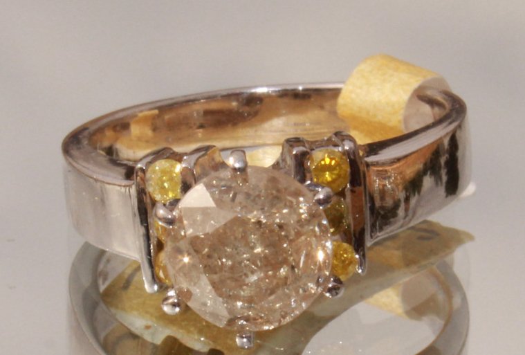 Round Cut Diamond Solitaire in White Gold: Total weight on the diamond is 1.45 ct. Size: 5 1/2. Weight is 5.62 grams.