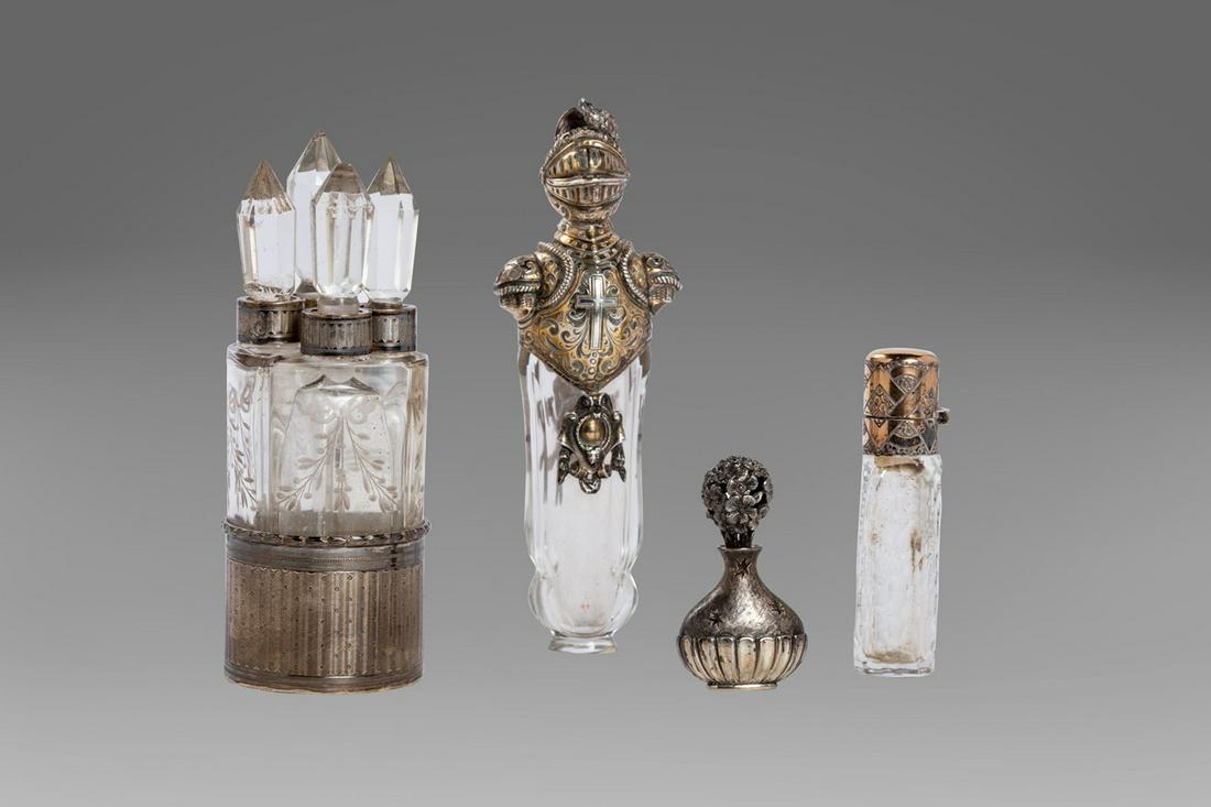 Lot consisting of 4 crystal and silver perfume holders: height 11.5 cm (the largest, with an armiger's head) two broken and restored caps, a small bottle with chips