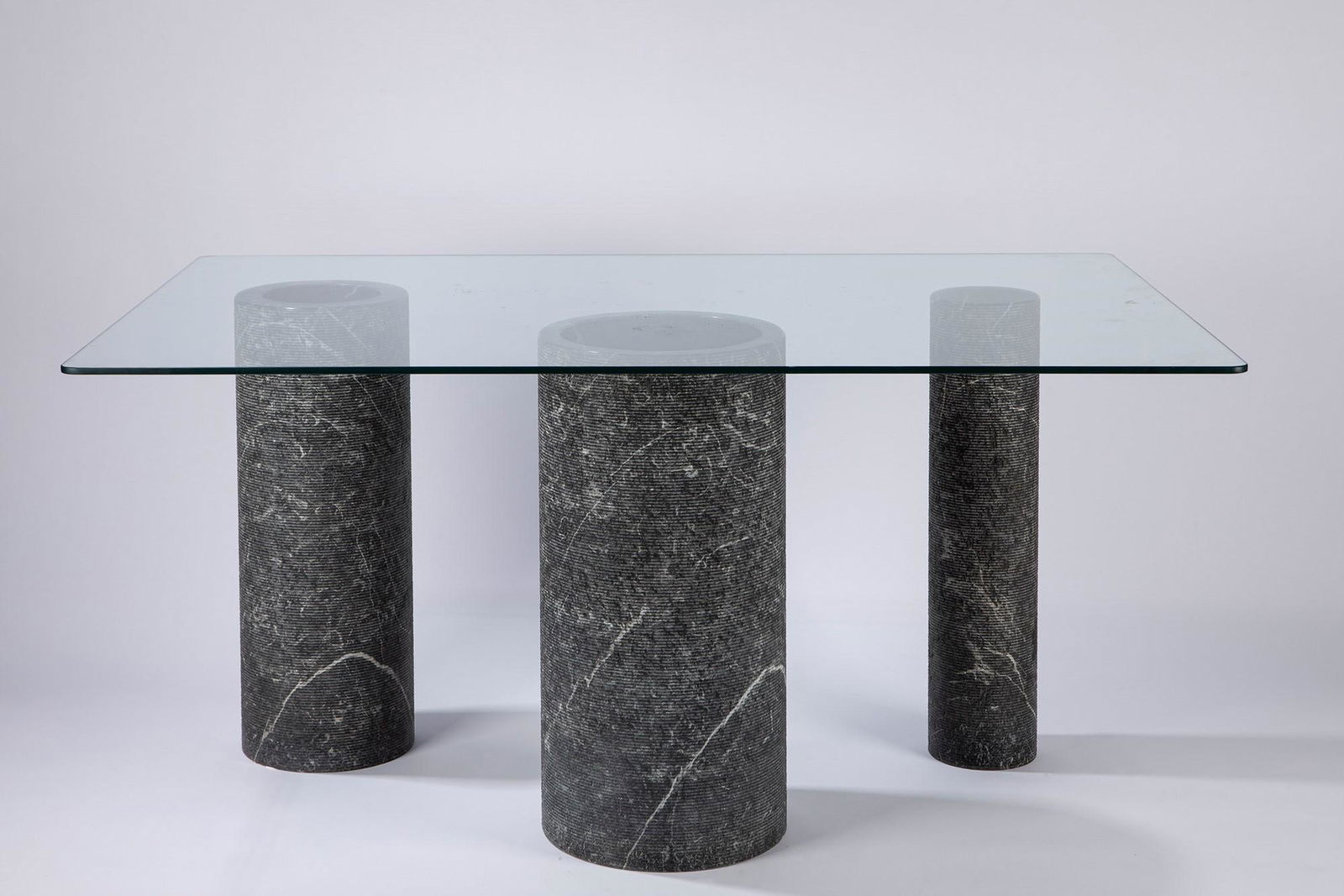 Lazzotti, Giulio - One table: One table, 1970 ca. cm h 71x95x145 three black marquinia marble columns, glass plane. Casigliani International Design LITERATURECasigliani catalogue
