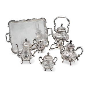 A silver tea and coffee service, Italy 19th Century: Composed of a tray, teapot, coffee pot, sugar bowl, milk jug and samovar. Weight kg 8,220 tray cm 68,00x40,00 samovar h cm 45,00 teapot h cm 26,00 coffee pot h cm 27,00 milk jug h cm 19,00