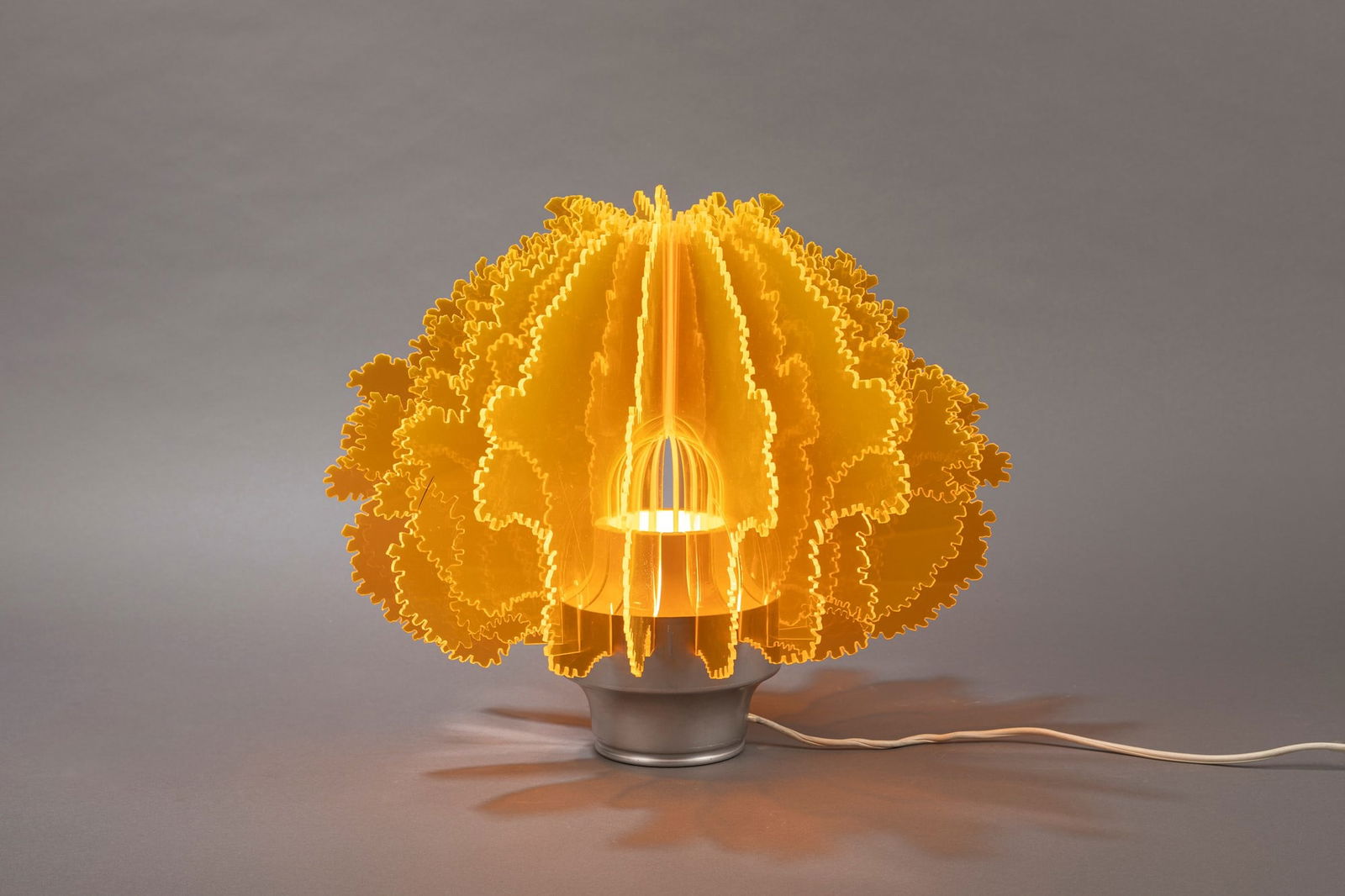 Ennio Lucini - Cespuglio , 1968: H 30 x 40 cm Table lamp. Satin and white lacquered aluminum, yellow plexiglass. Harvey Guzzini Manufacture. LITERATURE1000 Lights, vol. 2, Taschen, Koln 2006, p.138