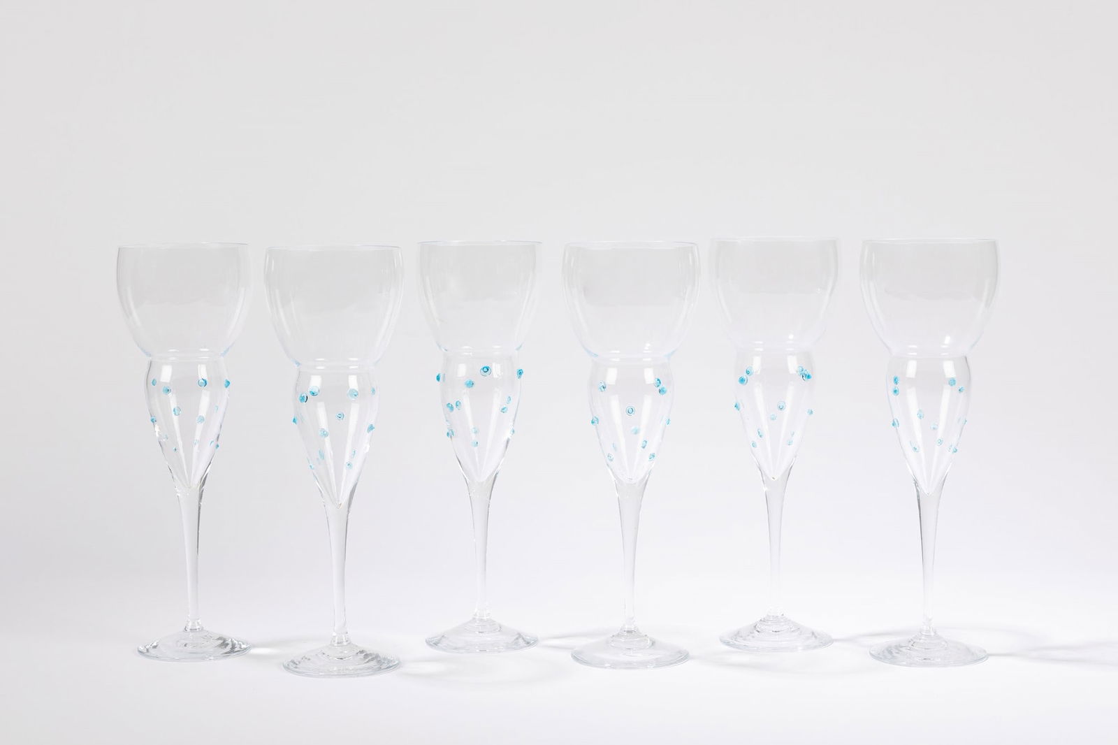 David Palterer (1949) - Set, 1990 ca.: h 22 x diam 6,5 cm composed by 6 blown glass goblets with applied blue glass details.Manufactured by Cleto MunariSignature engraved on glassOriginal brochure