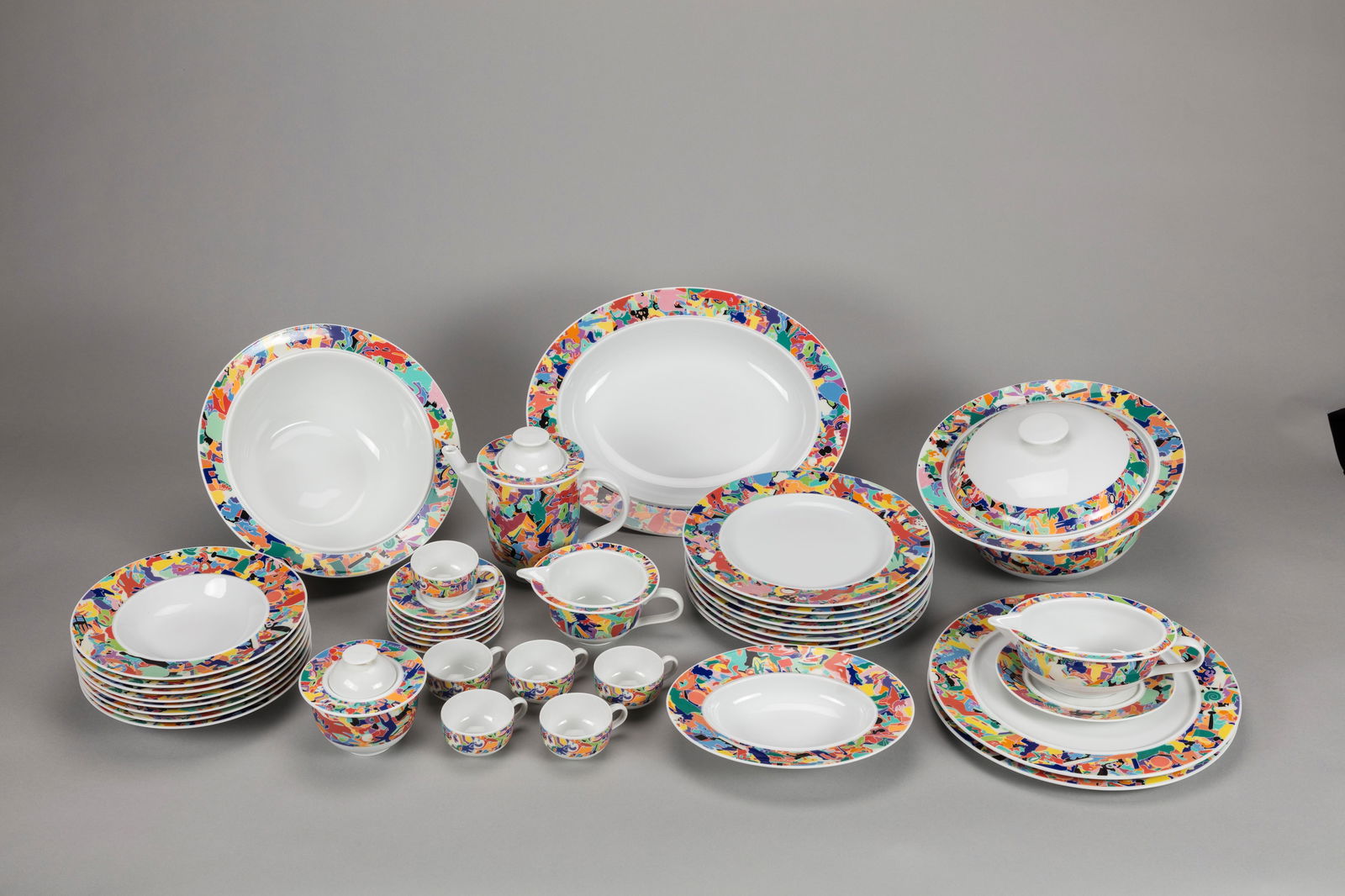 Alighiero Boetti (Torino 1940-Roma 1994) - Set, 1990 ca.: different sizes composed by eight flat plates, eight soup plates, one bowl, one soup tureen, one gravy boat, two oval serving plates, one large and one small, one coffee pot, one teapot, and eight cup