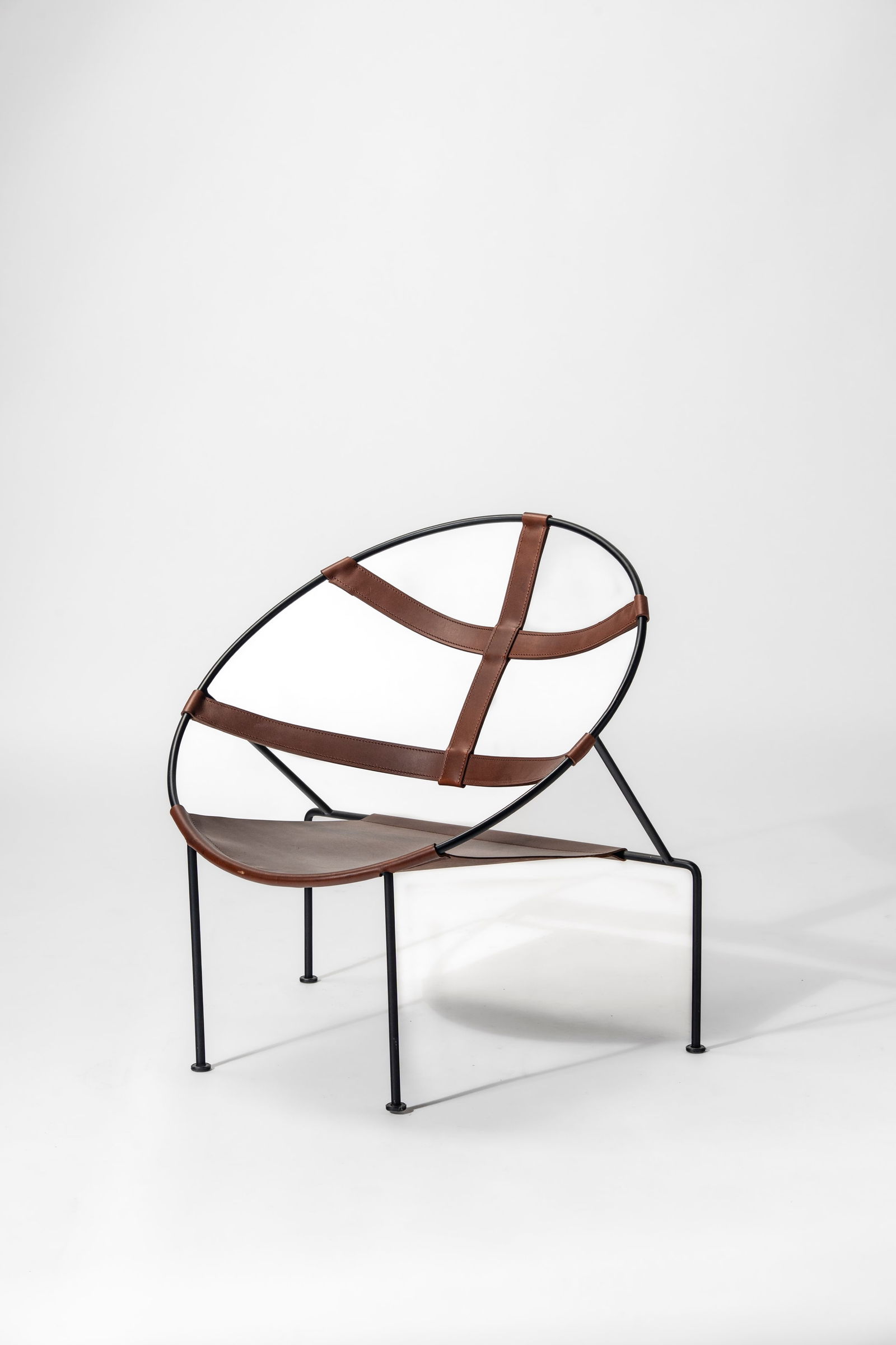 Flavio De Carvalho - Armchair model 'FDC1', 1950 circa: 81,5 x 80,5 x 70 cm Armchair model 'FDC1' with lacquered curved metal structure and seat in leather designed in 1950 circaexecuted in 2000 circaleather, painted metalObjecto edition, France PROVENANCE