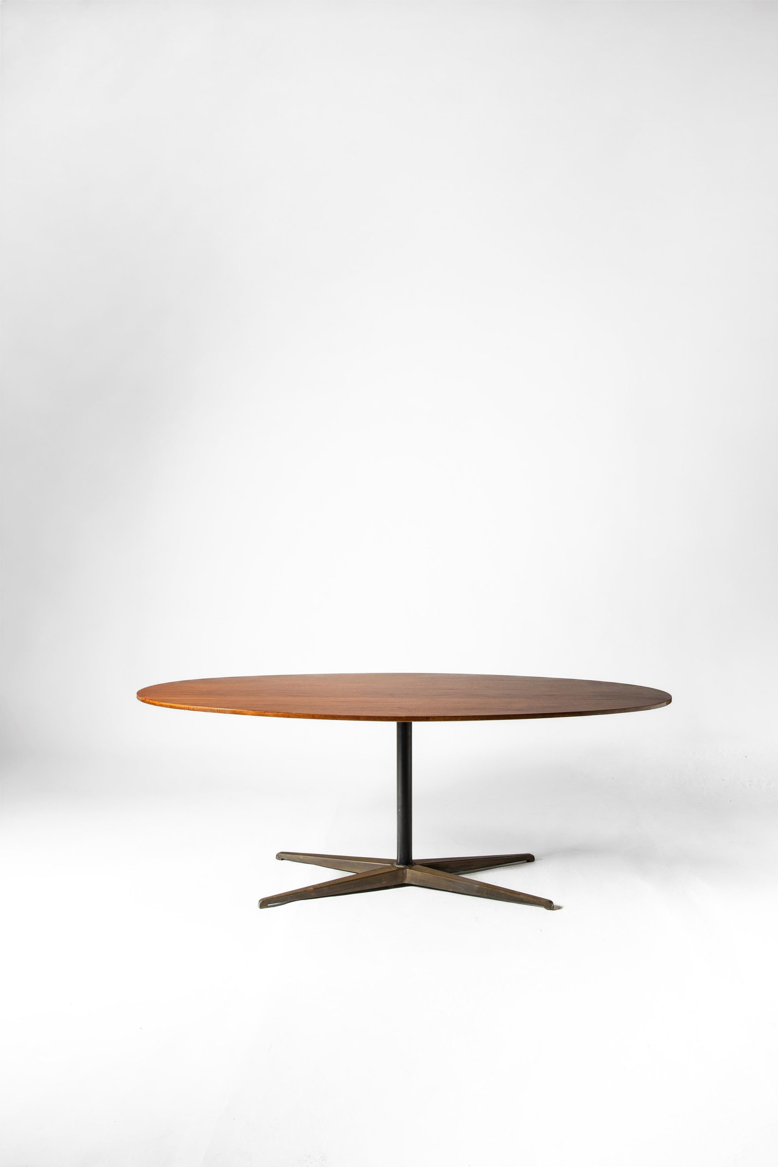 Gio Ponti (Milano 18 novembre 1891 - 16 settembre 1979) - Oval table model no. BT201, 1950: 74 x 200 x 104 cm designed in 1950mahogany veneer, opaque lacquered iron, brassRima edition, Padova, Italy EXHIBITIONS IX Triennale, Milan, May 1951, section 'Ospitalità' (for the series) LITERATURE 
