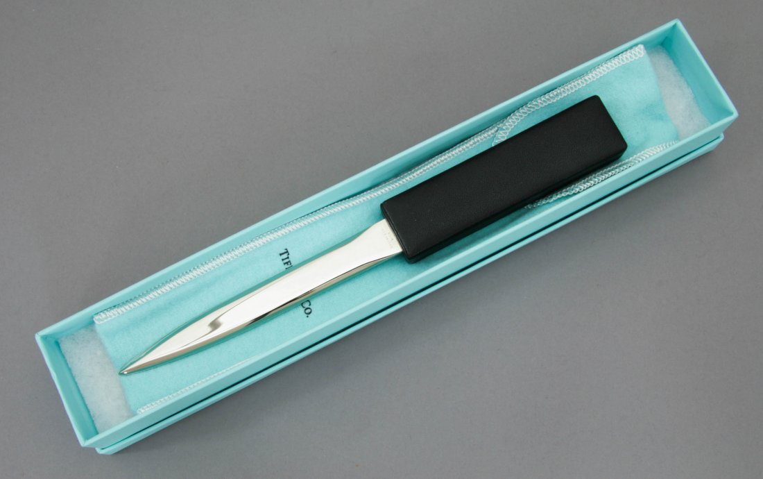 Tiffany & Co. Stainless Steel and Leather Letter Opener: A stainless steel blade with a leather handle letter opener. The letter opener measures just over 8 1/2 inches long and comes in its original box. The blade is clearly hallmarked.