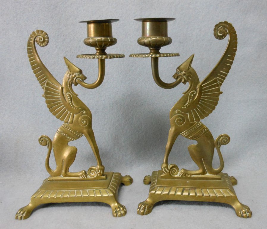 Antique Victorian Gothic Griffin, Gargoyle Candlesticks: A pair of antique Victorian, Gothic Candlesticks. The Candlesticks are made of brass and are in the figural form of Griffins or Gargoyles. Each candlestick measures 7 5/8" high x 4 1/2" wide and 3" de