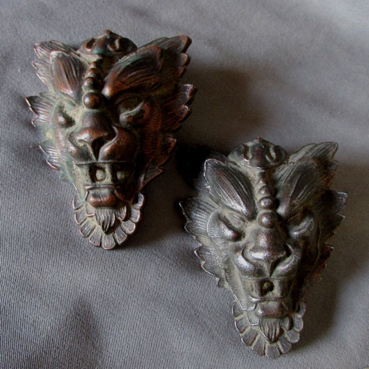 Pair of Gothic Gargoyle Face Architectural Elements: A nice pair of antique Victorian, Gothic Gargoyle Faces. The Gargoyles are made of spelter metal with a bronze toned finish and each measures 3 1/4" high x 2 1/2" wide. They have a threaded rod on the